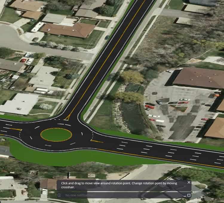 Hình ảnh từ trên cao vòng xuyến trên đường phố bao quanh bởi nhà dân và cây xanh, thể hiện tác động của quy hoạch đô thị hợp lý. Nhờ OpenRoads ConceptStation, các tuyến đường nối liền qua vòng xuyến một cách mạch lạc.